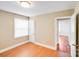 Bright and neutral bedroom with natural light and door to another room at 2405 Greenland Ave, Charlotte, NC 28208
