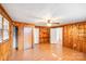 Bedroom with wood paneling, ceiling fan, and closet space at 2405 Greenland Ave, Charlotte, NC 28208
