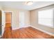 Bedroom featuring wood floors, trim, and two entry points at 2405 Greenland Ave, Charlotte, NC 28208