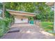 Covered carport with room for multiple vehicles and adjacent storage shed at 2405 Greenland Ave, Charlotte, NC 28208