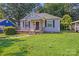 Charming one story home with an inviting porch and fresh green lawn at 2405 Greenland Ave, Charlotte, NC 28208