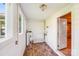 Bright sun room with wood floors, white walls, and access to outside at 2405 Greenland Ave, Charlotte, NC 28208