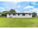 Back exterior view showing white painted brick and yard at 2610 Fairgreen Dr, Gastonia, NC 28056