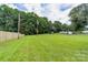 Large backyard with play structure, storage building, and fencing at 2610 Fairgreen Dr, Gastonia, NC 28056