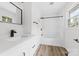 This renovated bathroom has modern fixtures, a white vanity, and a shower-tub combo at 2610 Fairgreen Dr, Gastonia, NC 28056