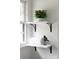 Bright bathroom shelving with a white towel, green plant, and a cute decoration at 2610 Fairgreen Dr, Gastonia, NC 28056