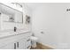 This bathroom features a white vanity with black hardware, a modern mirror, and new fixtures at 2610 Fairgreen Dr, Gastonia, NC 28056