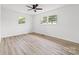 Bright bedroom features a ceiling fan, windows, and wood-look floors at 2610 Fairgreen Dr, Gastonia, NC 28056