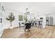 Open-concept dining area with modern table set, stylish light fixture, and access to kitchen at 2610 Fairgreen Dr, Gastonia, NC 28056