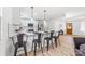Kitchen island offers extra seating and a view into the adjacent dining and living areas at 2610 Fairgreen Dr, Gastonia, NC 28056