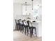 Modern kitchen island with white countertops, bar stools, and pendant lighting at 2610 Fairgreen Dr, Gastonia, NC 28056