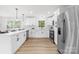Bright kitchen featuring white cabinets, a quartz countertop, and stainless steel appliances at 2610 Fairgreen Dr, Gastonia, NC 28056