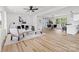 Bright living room featuring hardwood floors, modern furnishings, and an open floor plan at 2610 Fairgreen Dr, Gastonia, NC 28056