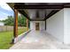 View of a covered patio with a concrete floor and white brick and wood support columns at 2610 Fairgreen Dr, Gastonia, NC 28056