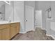 Bright bathroom features a wooden vanity, neutral walls, and wood-look vinyl flooring at 280 Glenn Allen Rd, Mooresville, NC 28115