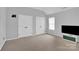 Bedroom with neutral carpet and paint, white doors, and tv at 280 Glenn Allen Rd, Mooresville, NC 28115