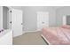 Neutral bedroom with pink comforter, white trim, and carpet flooring at 280 Glenn Allen Rd, Mooresville, NC 28115