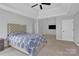 Large bedroom featuring a tray ceiling, multiple windows, and a spacious layout at 280 Glenn Allen Rd, Mooresville, NC 28115
