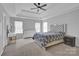 Spacious bedroom with a tray ceiling, multiple windows, and a large bed with decorative headboard at 280 Glenn Allen Rd, Mooresville, NC 28115