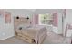 This bedroom features a neutral color palette, a large window, and built-in storage at 280 Glenn Allen Rd, Mooresville, NC 28115