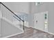 Bright entryway with wood-look floors, staircase, and view into a living area with plenty of natural light at 280 Glenn Allen Rd, Mooresville, NC 28115