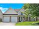 Charming two-story home featuring a stone facade, two-car garage, and inviting front porch with seasonal decorations at 280 Glenn Allen Rd, Mooresville, NC 28115