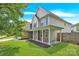 Charming home featuring a front porch, stone accents, manicured lawn, and mature trees at 280 Glenn Allen Rd, Mooresville, NC 28115