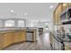 Bright, open-concept kitchen area with granite countertops, stainless steel appliances, and wood cabinets at 280 Glenn Allen Rd, Mooresville, NC 28115