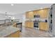 Open kitchen with stainless steel appliances, granite countertops, wood cabinets, and view to living area at 280 Glenn Allen Rd, Mooresville, NC 28115