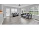 Comfortable living room featuring gray walls, two sofas, and natural light from multiple windows at 280 Glenn Allen Rd, Mooresville, NC 28115