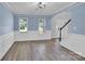 Cozy living room with light blue walls, white trim, wood-look flooring, and lots of natural light at 280 Glenn Allen Rd, Mooresville, NC 28115