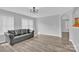 Relaxing living room with gray walls, a comfortable sofa, and natural lighting at 280 Glenn Allen Rd, Mooresville, NC 28115
