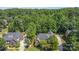 Secluded brick home with mature landscaping, long driveway, and detached garage, nestled amongst tall trees at 2909 Arbor Knl, Concord, NC 28025