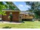 Expansive backyard view showing the deck, brick exterior, and lush lawn at 2909 Arbor Knl, Concord, NC 28025