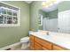 Green bathroom featuring a vanity with lots of storage, a commode and a shower/tub combo at 2909 Arbor Knl, Concord, NC 28025