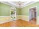 Bright dining room features beautiful hardwood floors, a large window and classic chandelier at 2909 Arbor Knl, Concord, NC 28025