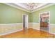 Spacious dining room with hardwood floors, chandelier, and decorative molding at 2909 Arbor Knl, Concord, NC 28025