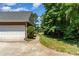 Long driveway leading to a home with a two-car garage and landscaped garden at 2909 Arbor Knl, Concord, NC 28025