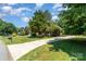 Charming home with manicured front lawn, lush trees, and long private driveway at 2909 Arbor Knl, Concord, NC 28025