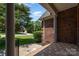 Charming brick home featuring a cozy front porch and tile flooring at 2909 Arbor Knl, Concord, NC 28025