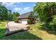 Two-car brick garage featuring an extra-long driveway and mature trees at 2909 Arbor Knl, Concord, NC 28025