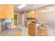 Kitchen view featuring granite counters, wooden cabinets and a breakfast bar with seating at 2909 Arbor Knl, Concord, NC 28025