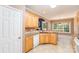 A bright kitchen features wooden cabinets, light countertops, and a breakfast bar with a view at 2909 Arbor Knl, Concord, NC 28025