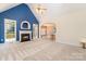 Spacious living room with a fireplace, large windows, and seamless flow to other rooms at 2909 Arbor Knl, Concord, NC 28025
