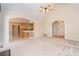 Bright, open living room with high ceiling, access to kitchen, and front entrance view at 2909 Arbor Knl, Concord, NC 28025