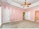 Spacious main bedroom featuring a trey ceiling, pink wallpaper, and multiple doorways at 2909 Arbor Knl, Concord, NC 28025