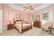 Cozy main bedroom with a four-poster bed, soft carpet, and bright windows at 2909 Arbor Knl, Concord, NC 28025