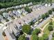 Aerial view of a neighborhood with a mix of townhomes and single-Gathering houses and mature trees at 298 Bridges Farm Rd, Mooresville, NC 28115