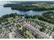 Aerial view of a neighborhood showcasing houses, a lake, and mature trees at 298 Bridges Farm Rd, Mooresville, NC 28115