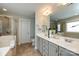 Luxurious bathroom with dual sinks, a glass-enclosed shower, and a separate soaking tub for relaxation at 298 Bridges Farm Rd, Mooresville, NC 28115